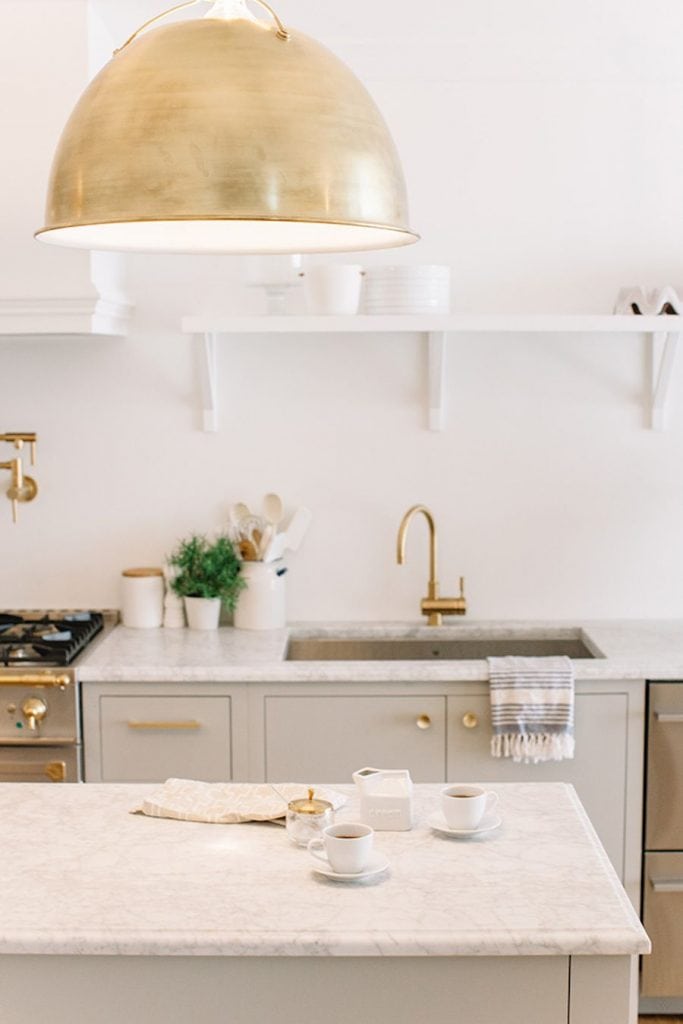 grey and gold kitchen with fabulous pendant light marble counters