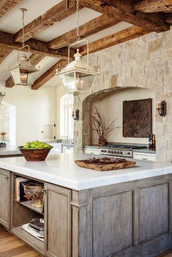 french farmhouse kitchen with antique lanterns and stone hearth