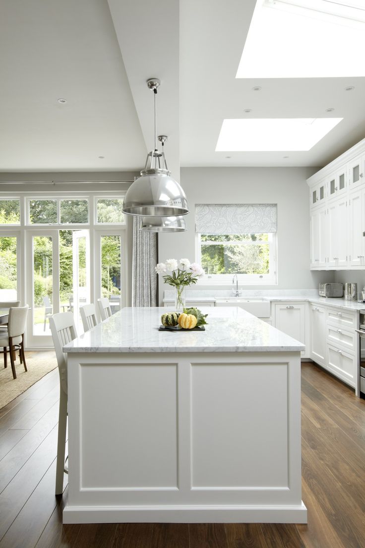 White Kitchen with Stacked Cabinets and Grey Island - Home Bunch