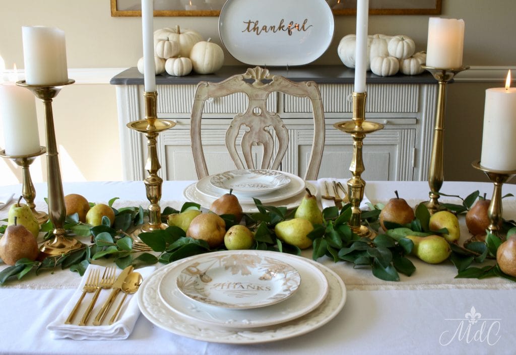 thanksgiving table gold candleholders pears and greens
