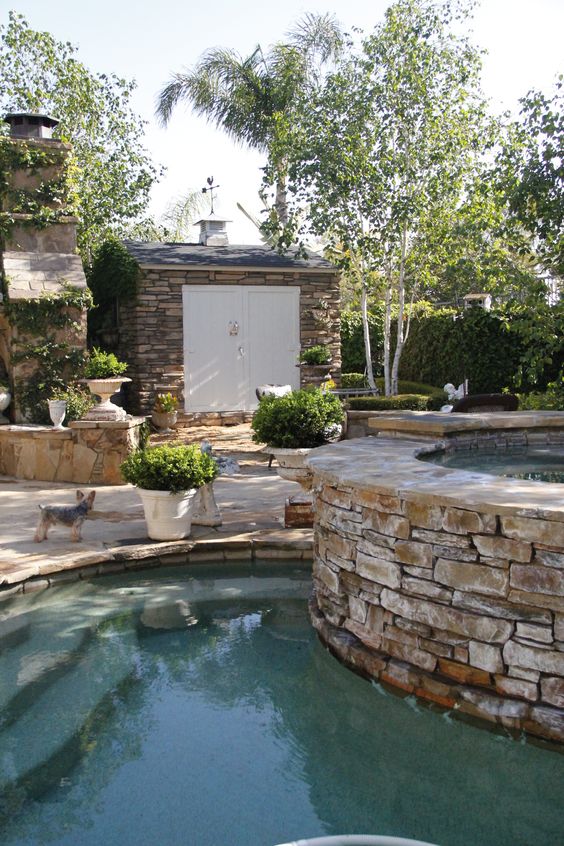 backyard renovation inspiration stone surrounding pool and shed charming french inspired yard