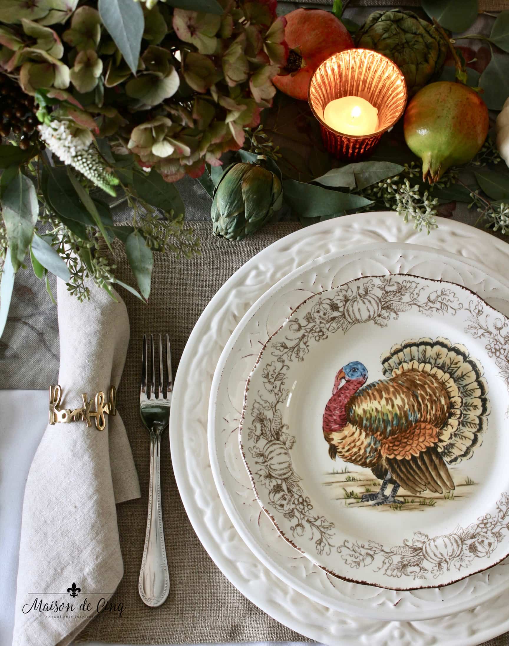 thanksgiving table setting with turkey plate and candles 