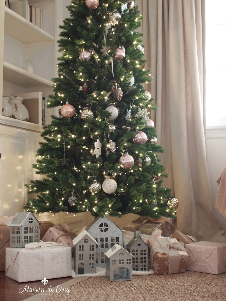 French farmhouse Christmas tree decorated in pink and white with galvanized houses and gifts holiday decor