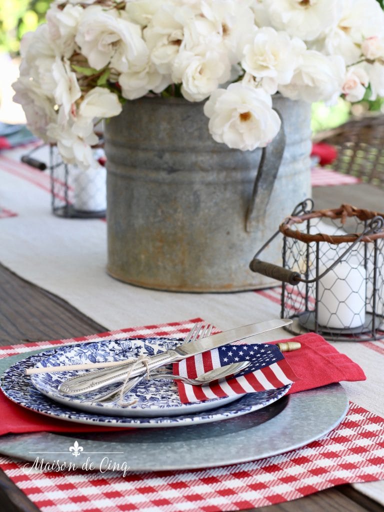 patriotic table setting red napkin and flag on blue floral plate