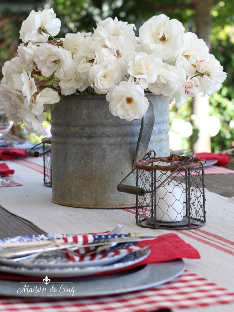 patriotic table setting with white roses in vintage zinc bucket fourth of july inspiration