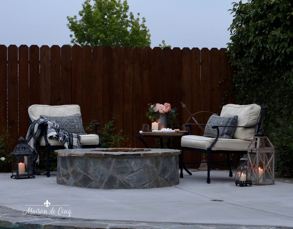 summer outdoor entertaining by the fire pit chairs lanterns candlelight