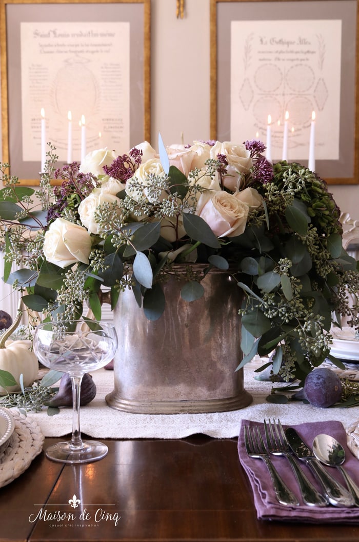 stunning centerpiece with purple and white flowers white pumpkins and figs 