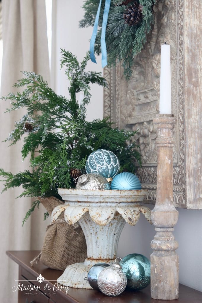 Christmas decorating pine tree blue ornaments in french urn 
