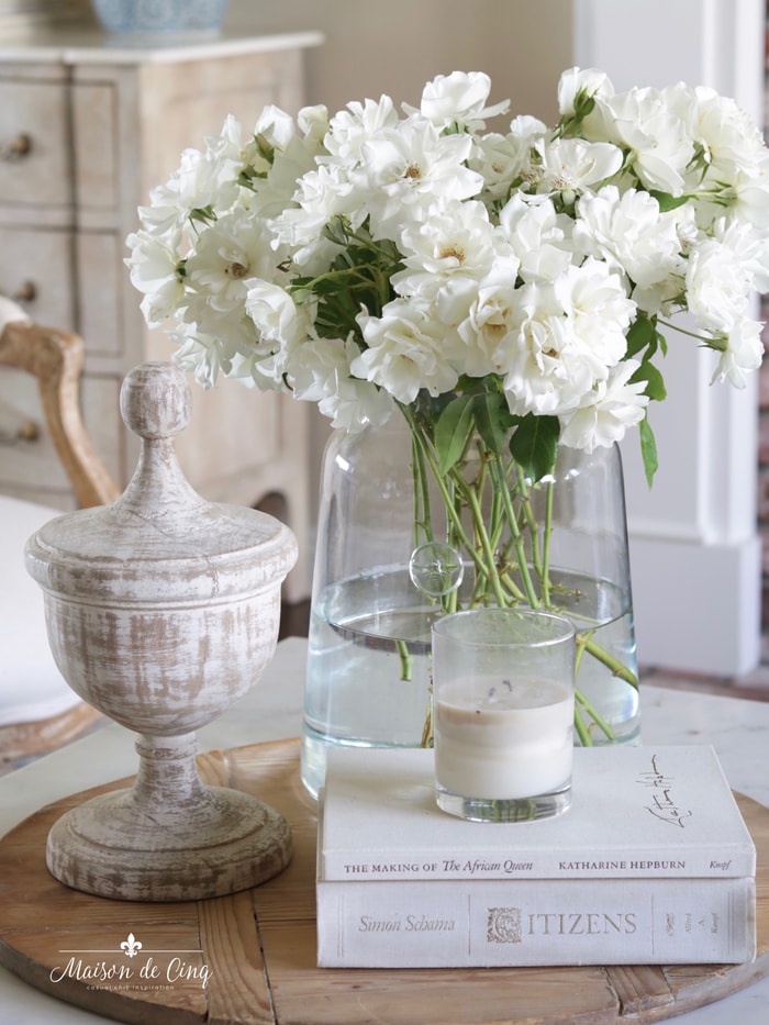 flowers urn and books on bread board coffee table decorating ideas 