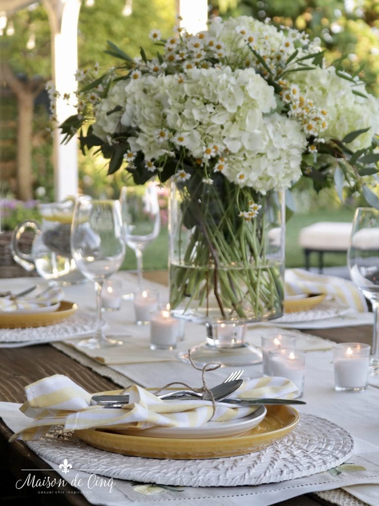 gorgeous summer flowers on yellow and white summer tablescape 