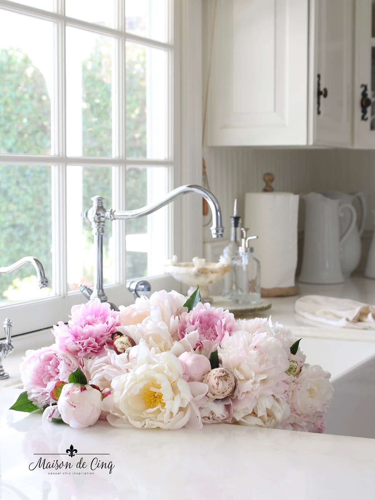 peonies in the sink in white French kitchen 