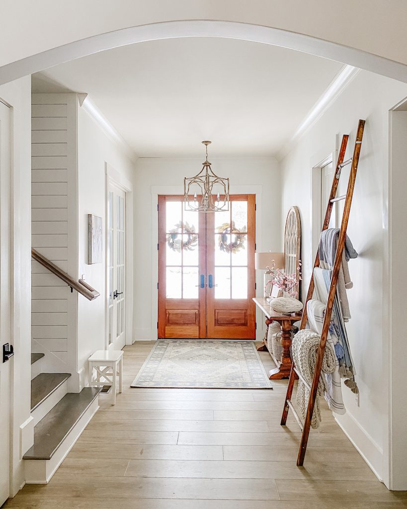modern farmhouse style entry way with wood French doors 