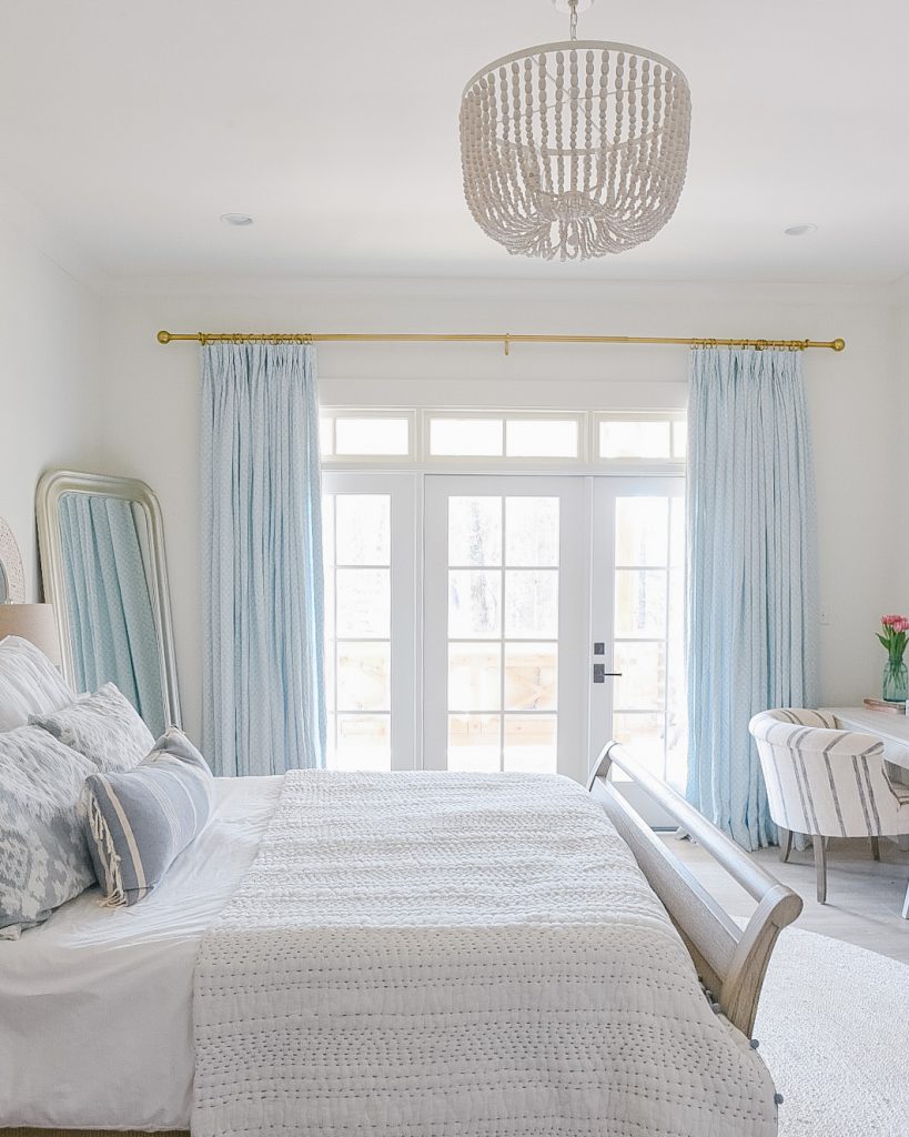 gorgeous blue and white bedroom with pale blue drapes 