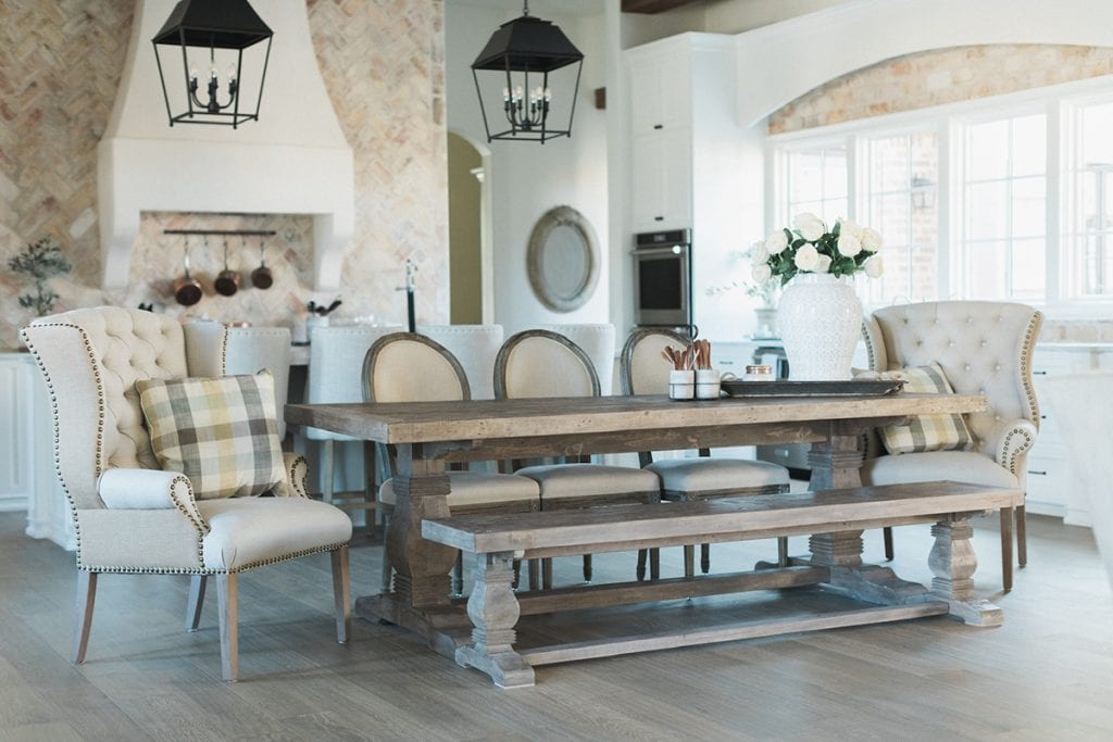 french farmhouse style kitchen with farmhouse table and beautiful rustic lanterns 