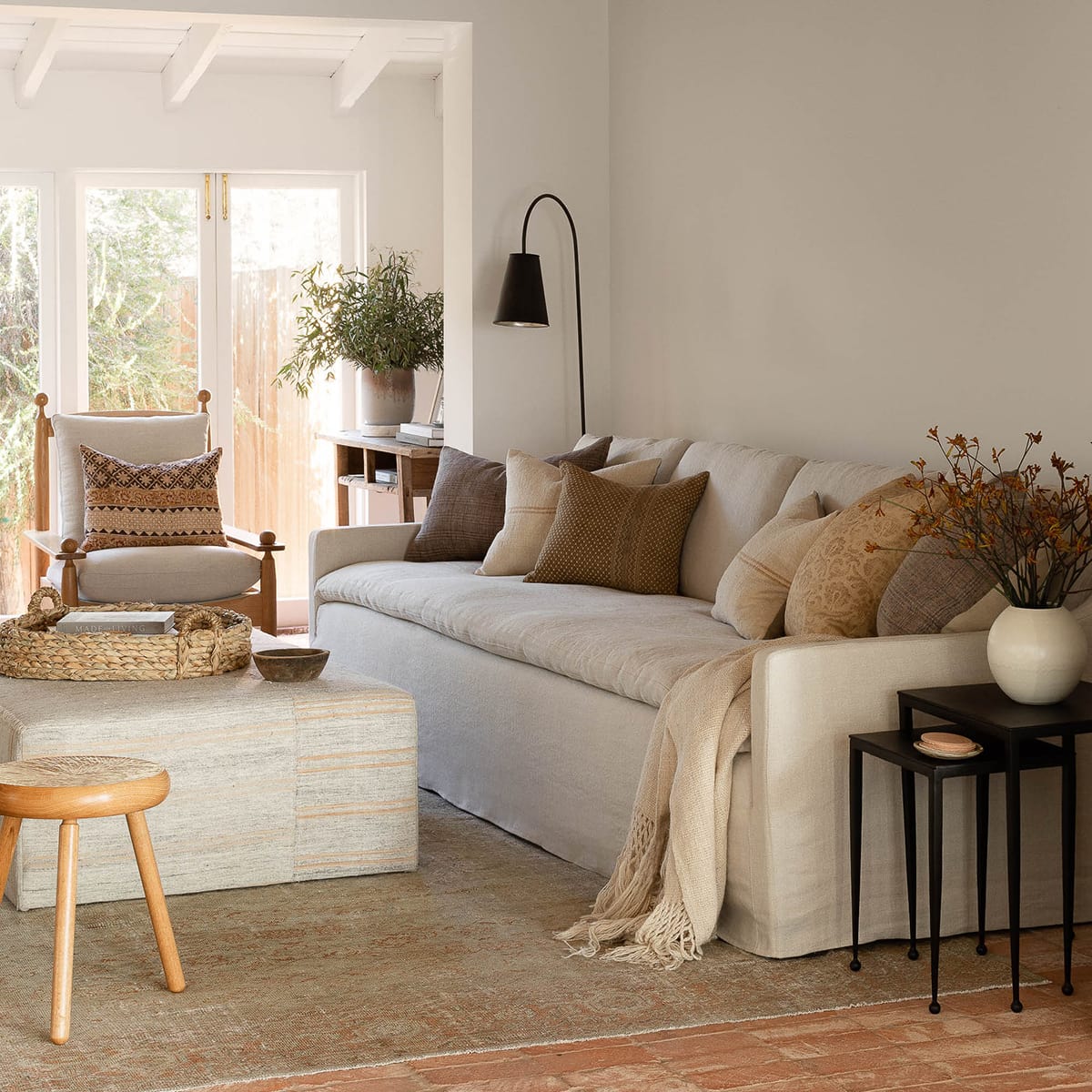 modern textural living room with linen sofa and earth tone pillows 