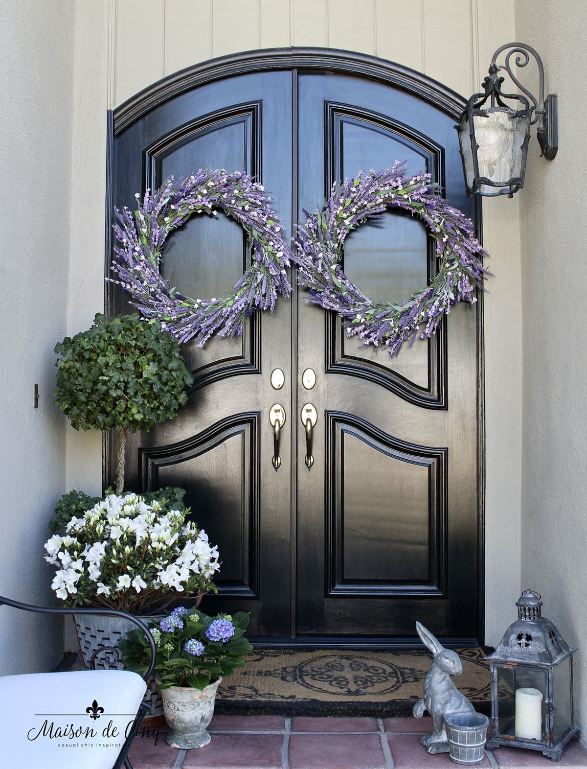 spring porch with lavender wreaths topiary and bunnies 