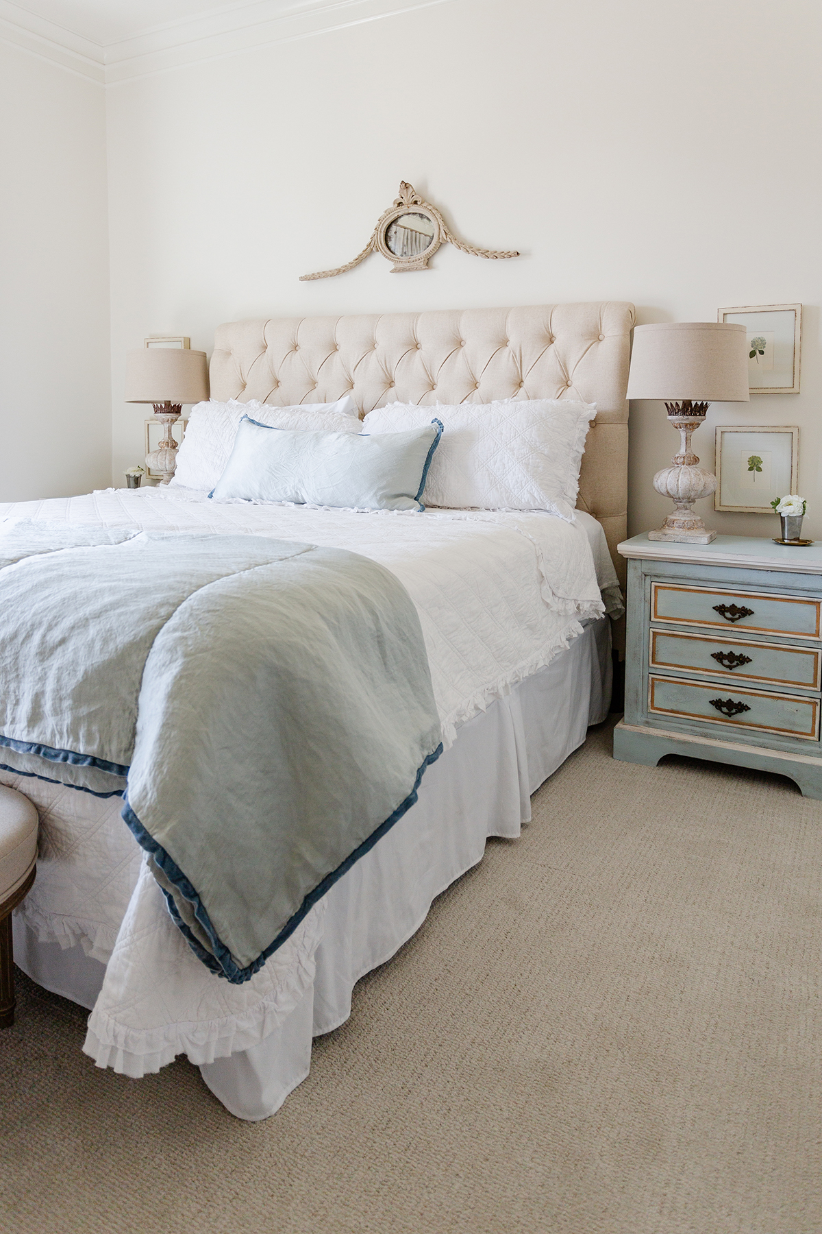 French farmhouse style bedroom tufted headboard neutral with French blue accents 