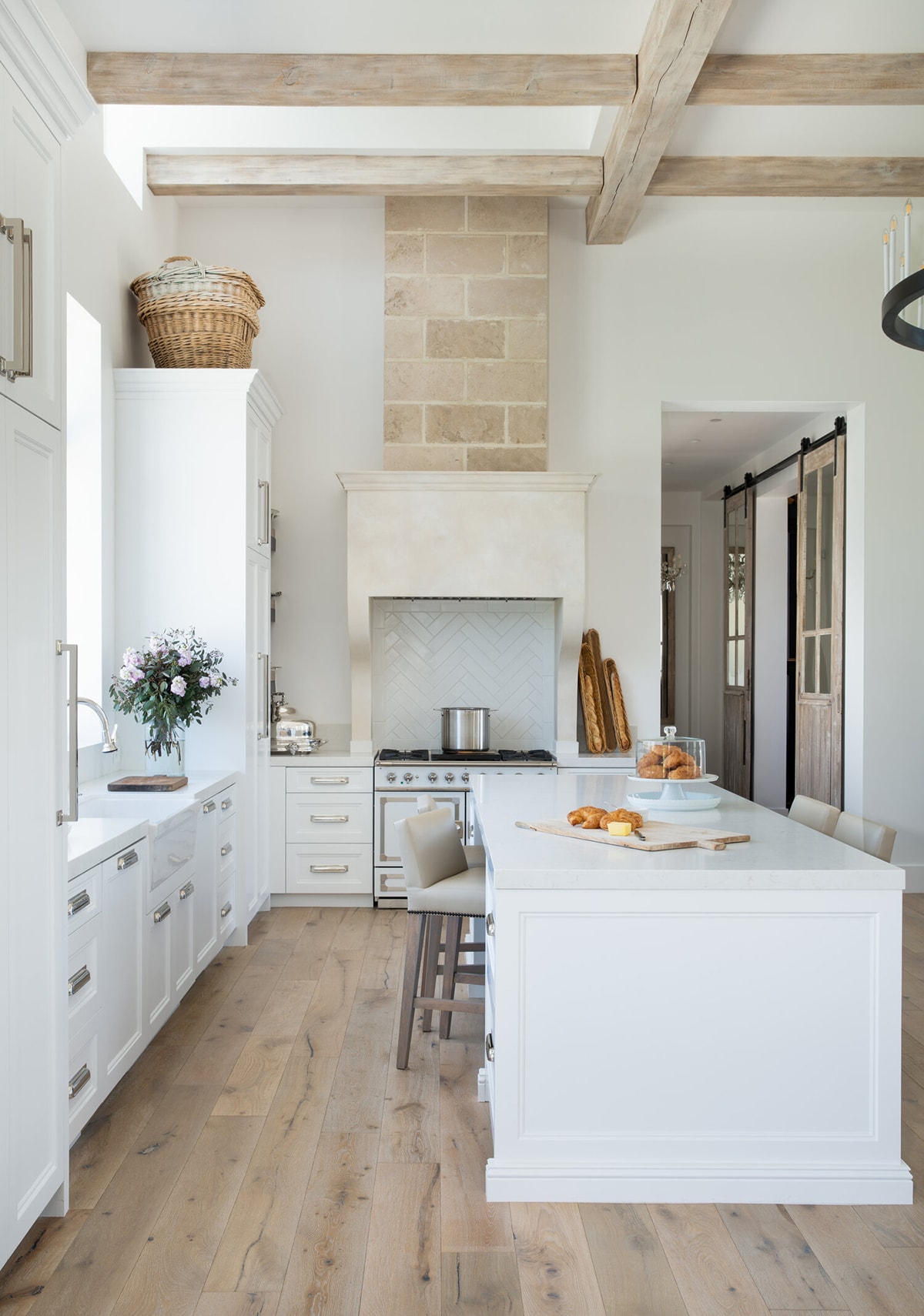 rustic French kitchen with aged stone and beams wood floors