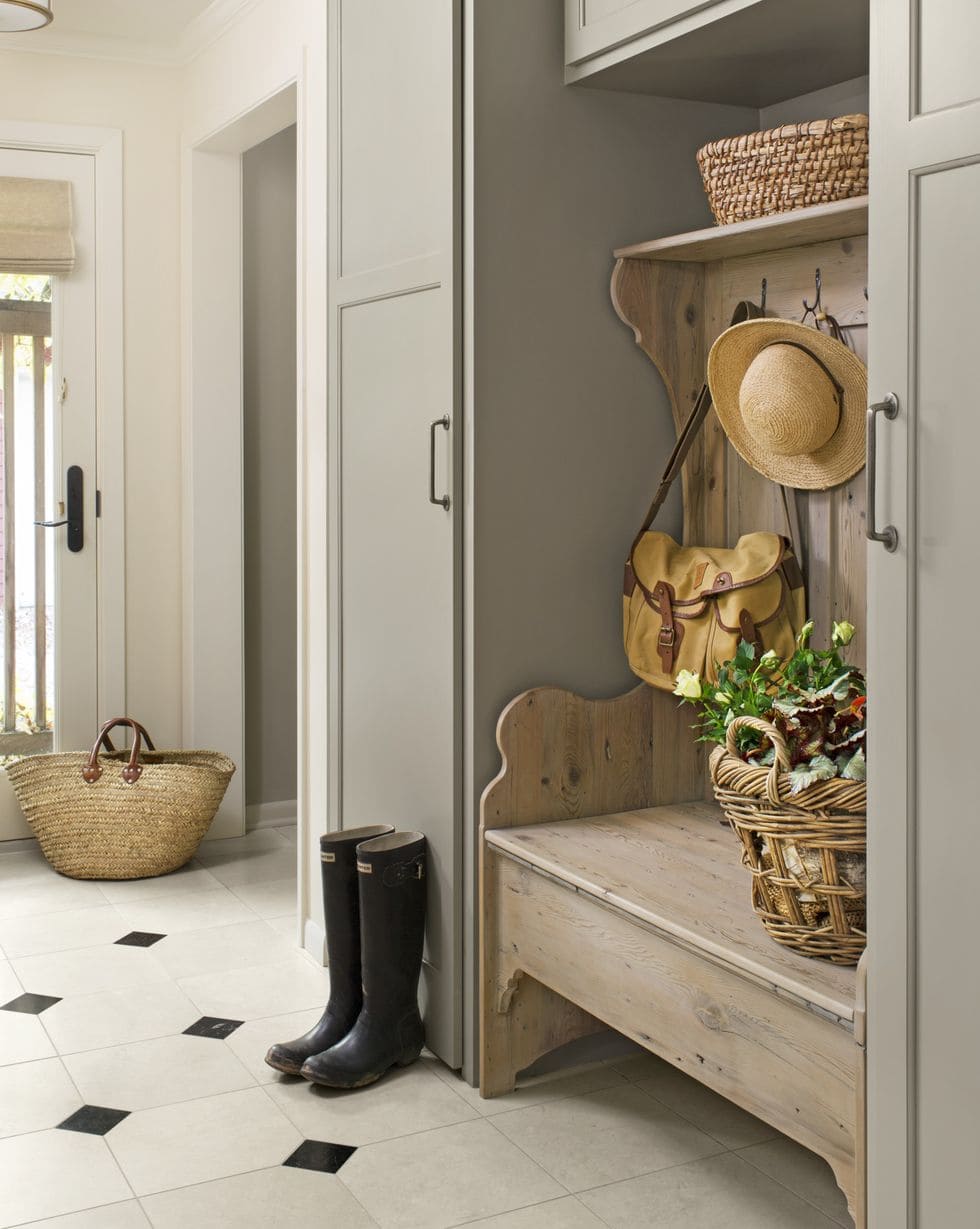 european style mudroom with mushroom taupe paint and vintage bench 