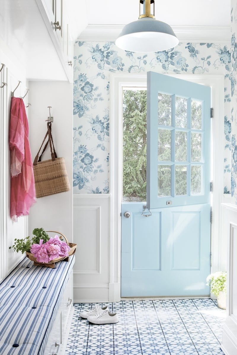 pretty mudroom with blue tile floors and wallpaper and blue dutch door 