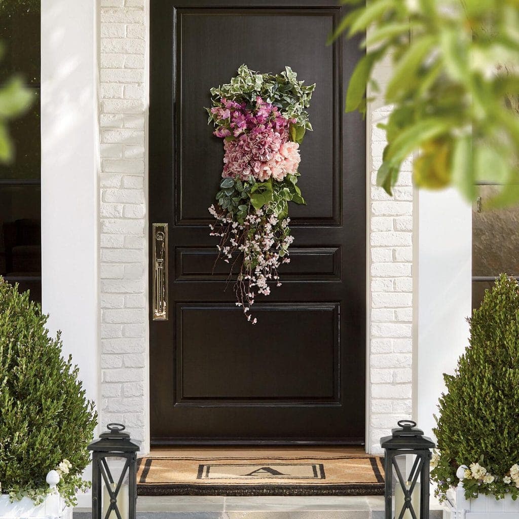 black door with gorgeous spring planter hanging flowers 