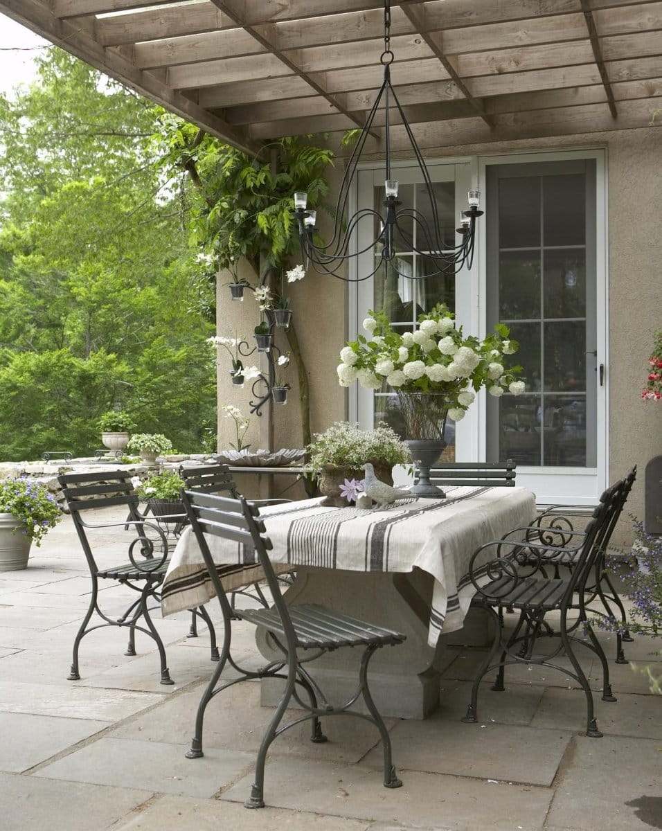 beautiful European style outdoor space with flowers and decor on dining table 