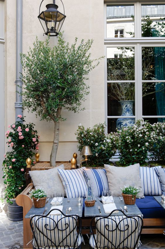 beautiful outdoor patio area with pillows French inspired outdoor decor 