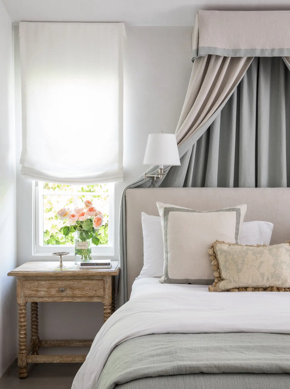 hottest design trends quiet luxury in a stunning and peaceful bedroo with pretty curtain treatment over bed 
