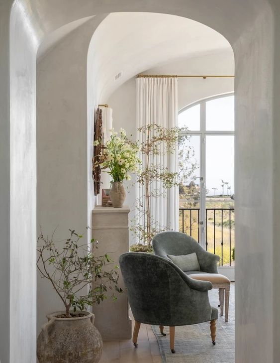 gorgeous French bedroom with plants in pots and green chairs 