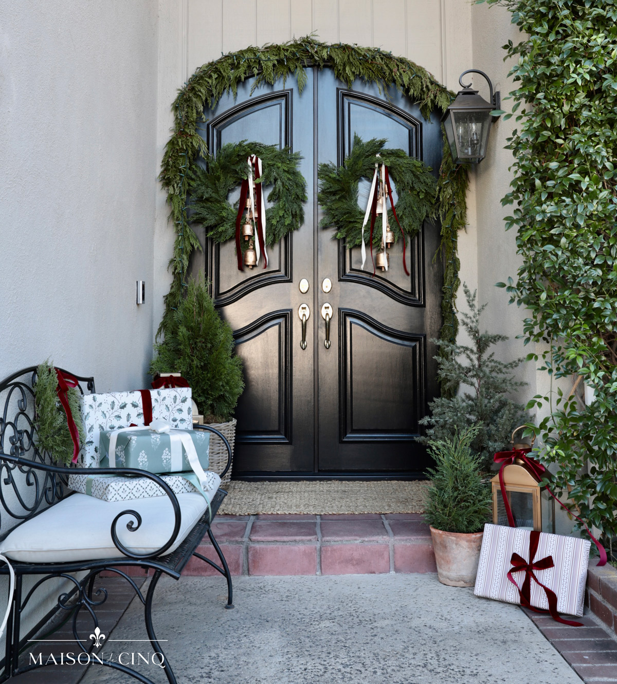 traditional Christmas porch with french doors wreaths garland and bench 