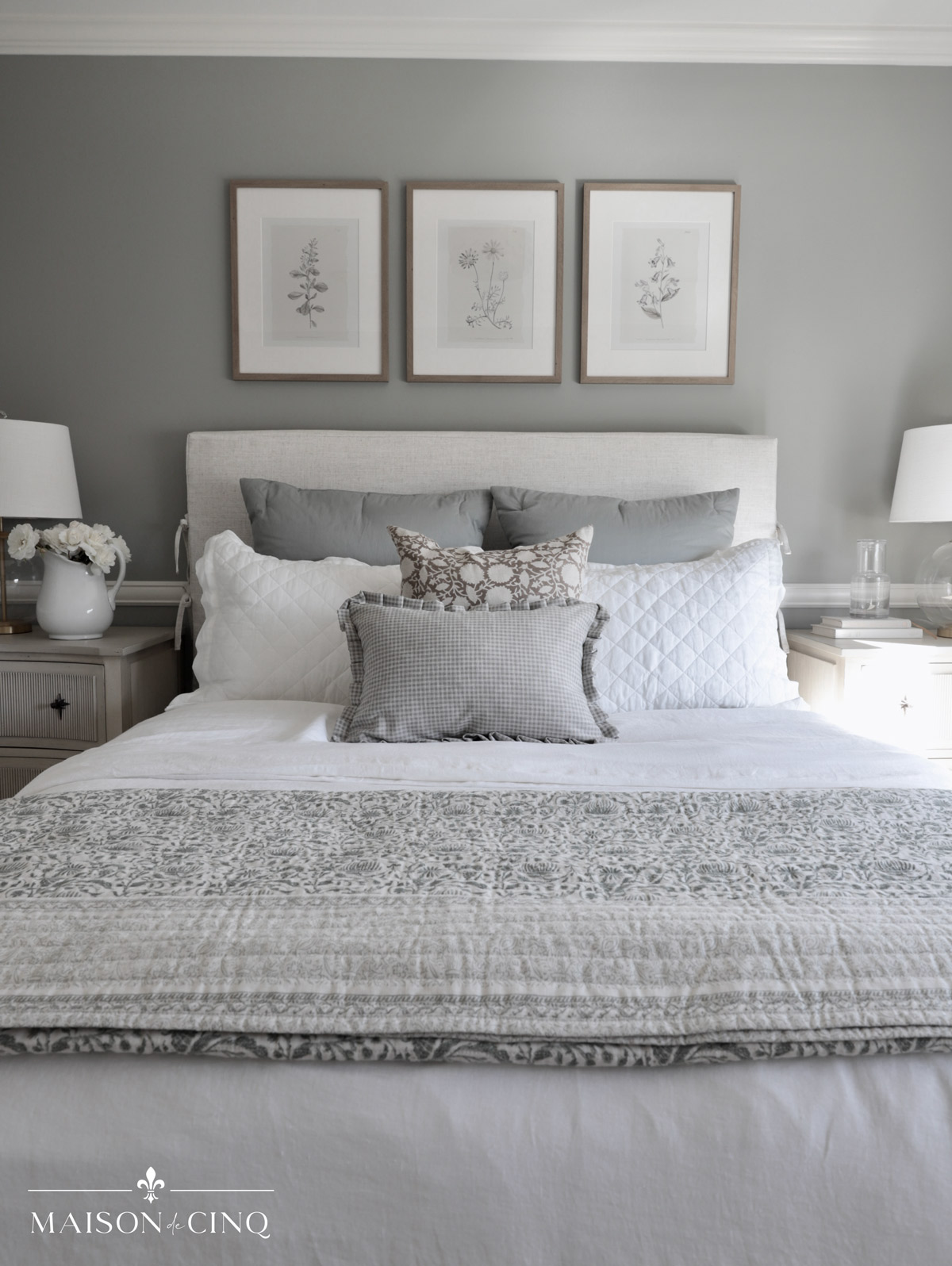 upholstered bed with green floral bedding in french-inspired guest bedroom makeover reveal 