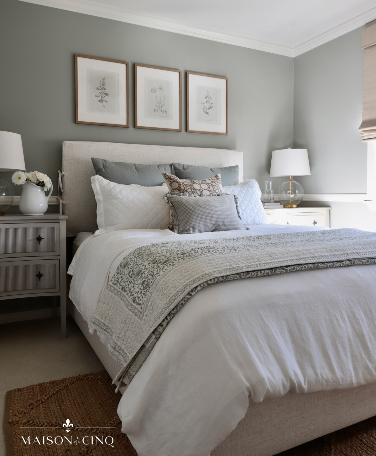 beautiful french-inspired bedroom with blue/green walls and neutral bedding 