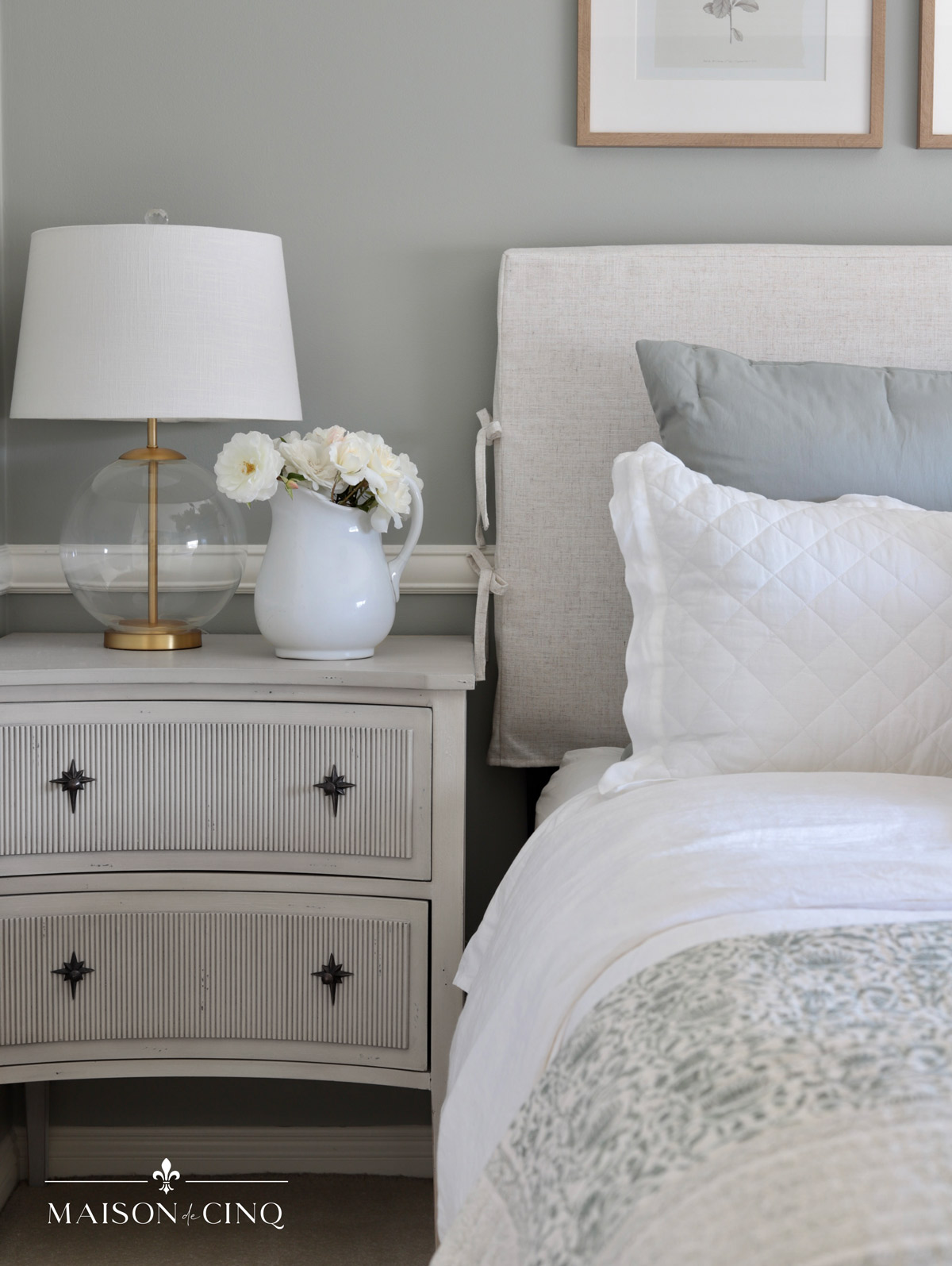 glass table lamp on swedish off-white nightstands in french bedroom
