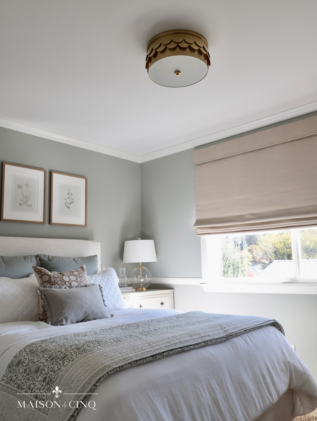 charming brass ceiling mount light fixture in french blue/green bedroom 