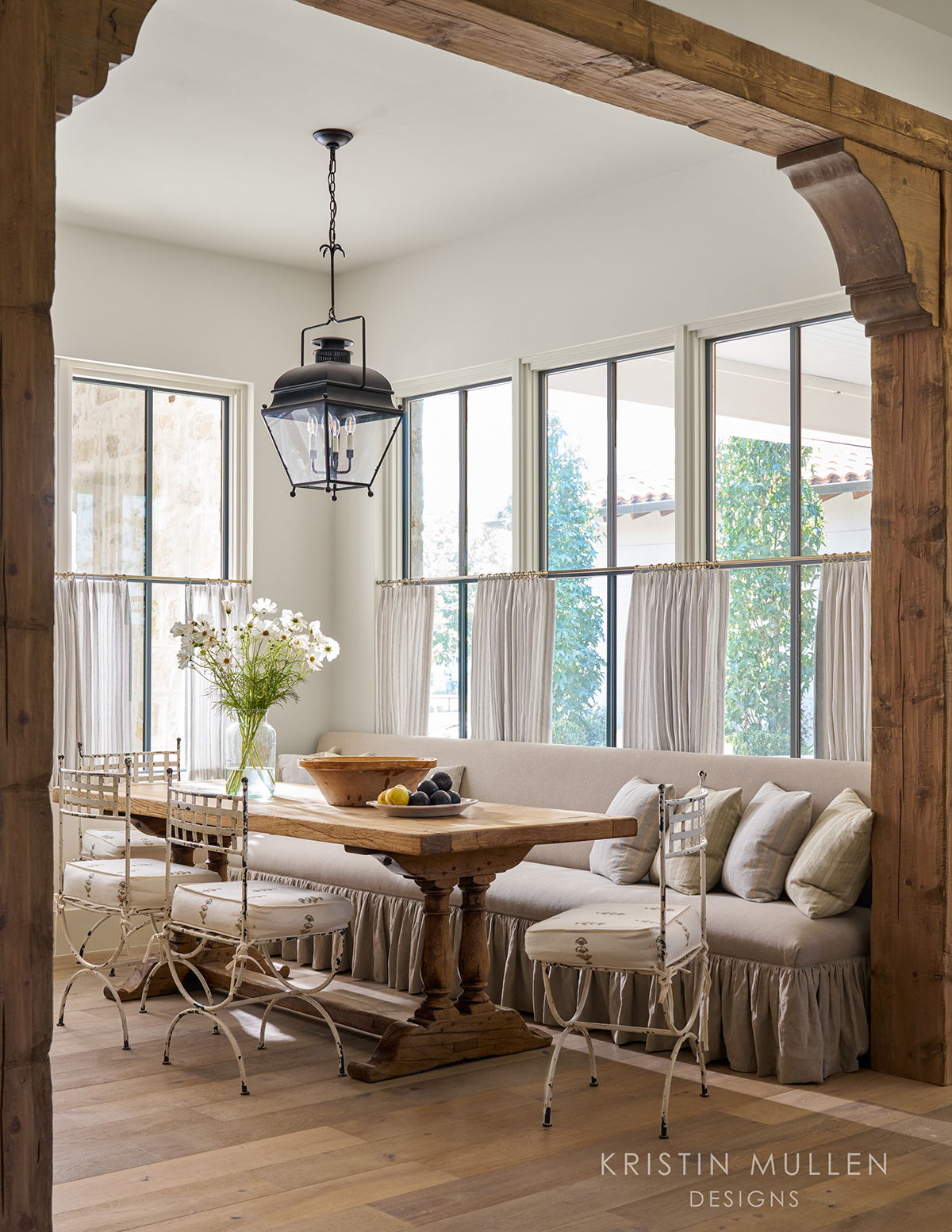 European style home breakfast room with antique lantern and farmhouse table rustic beams 