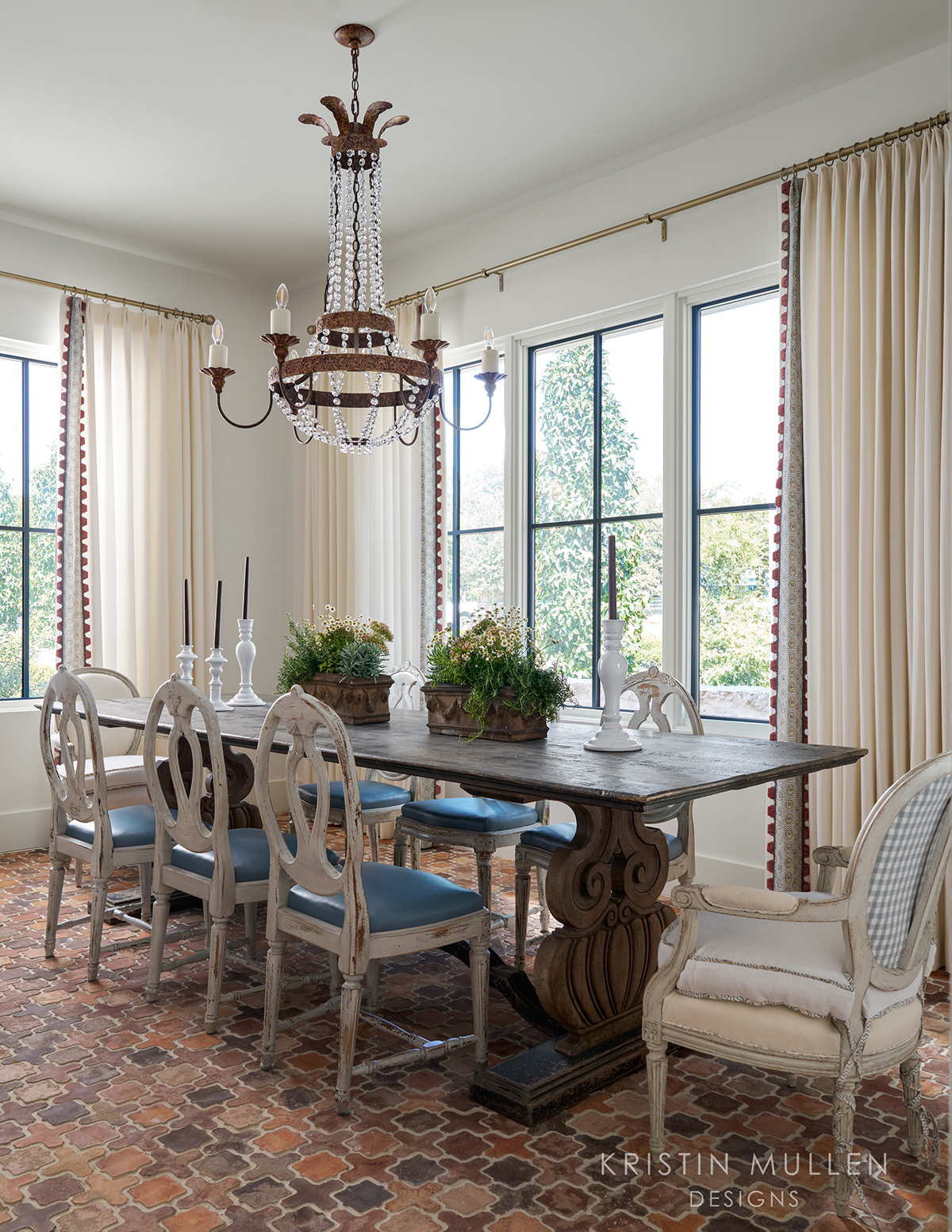 rustic dining room in European style home crystal chandelier and Swedish antique chairs 