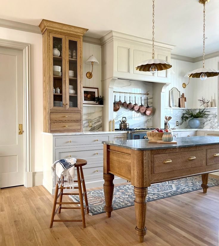 gorgeous English country style kitchen with wood island and pendant lights 