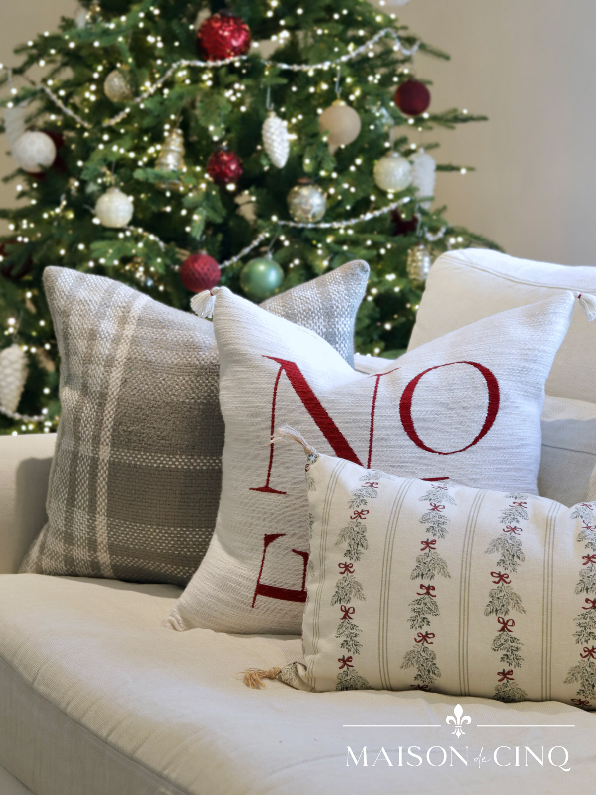 family room christmas decor with green and red pillows 