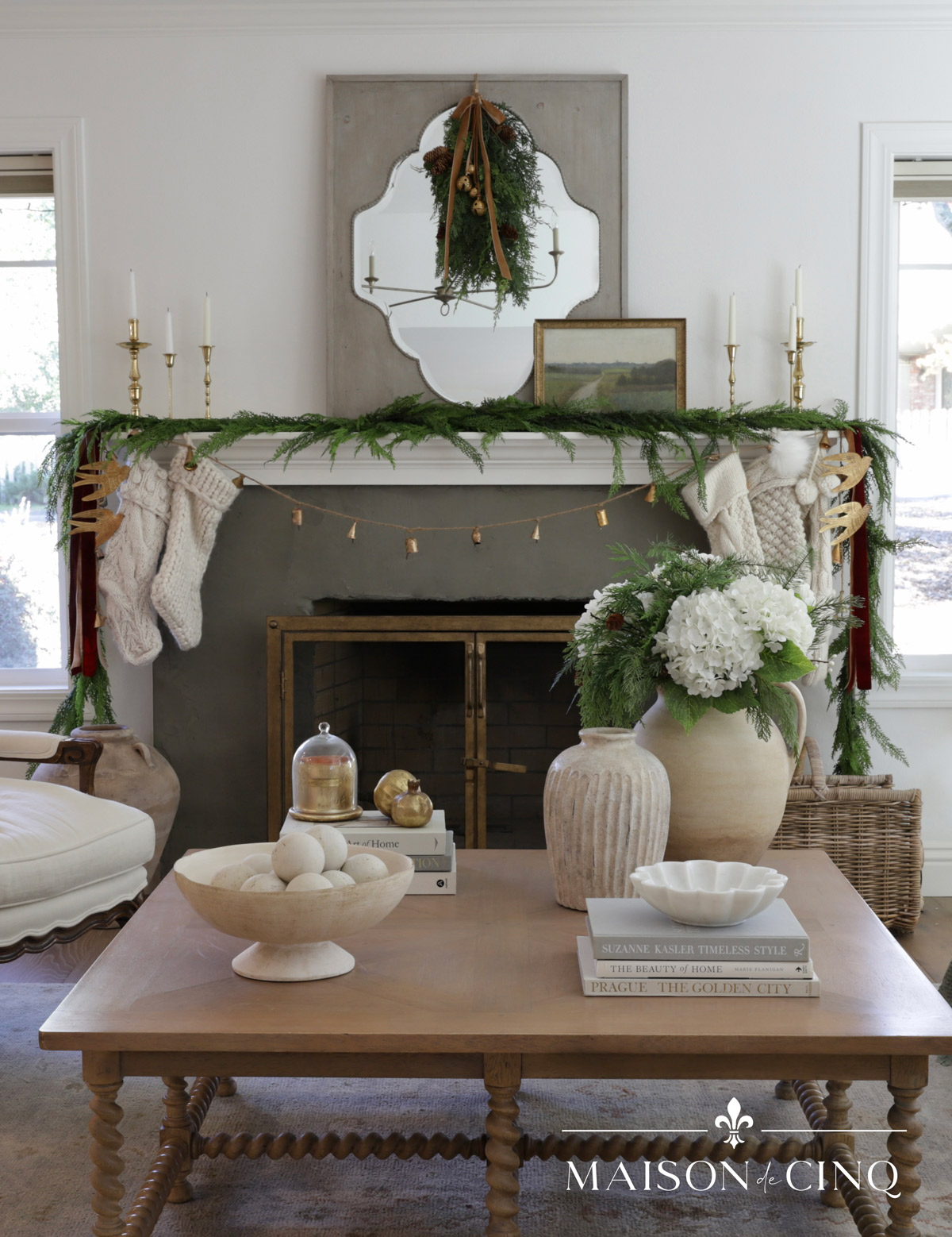 European-inspired Christmas tour with mantel decorated with garland knit stockings and greenery swag 