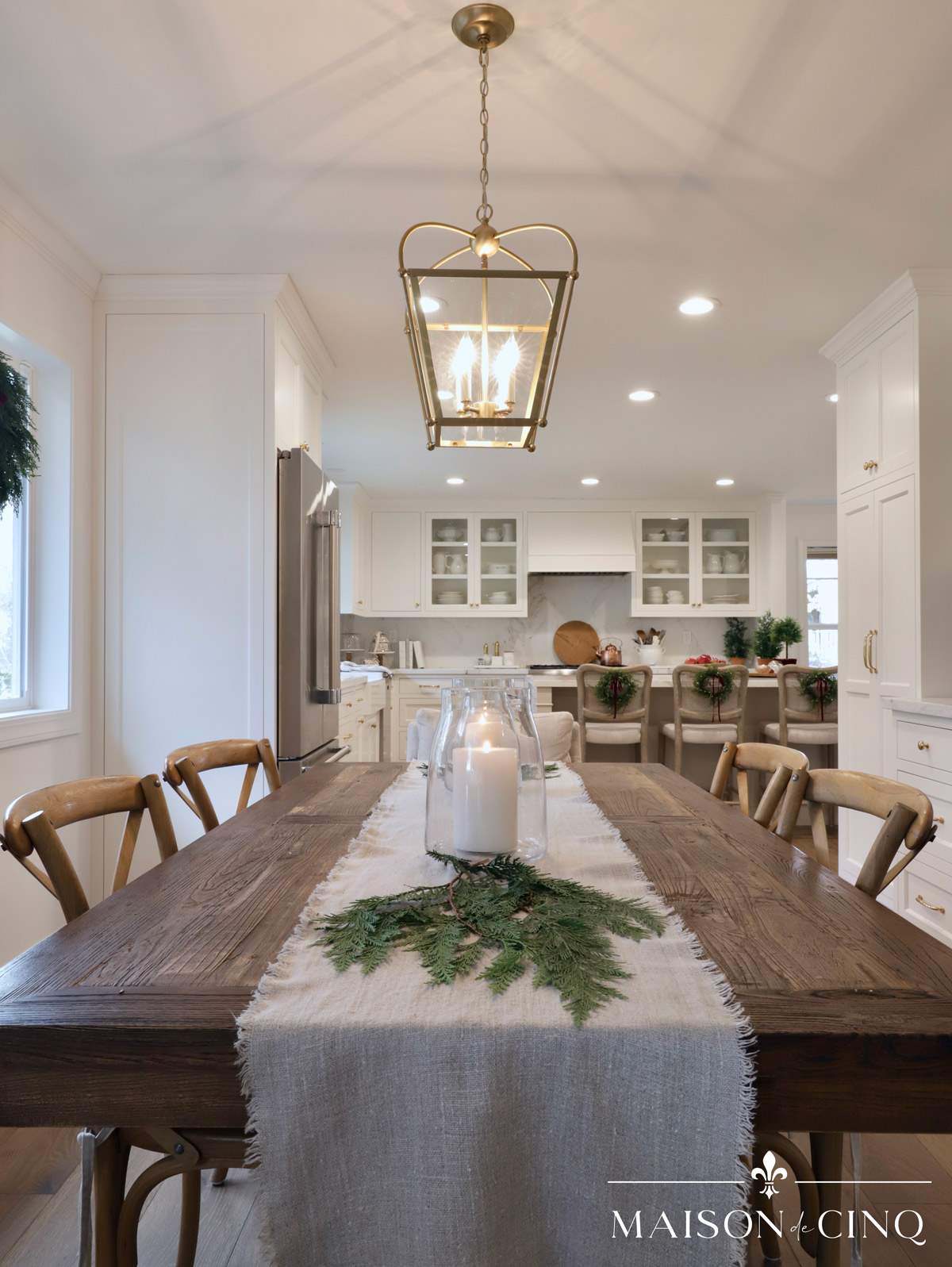 dining area with white French inspired kitchen decorated for Christmas 