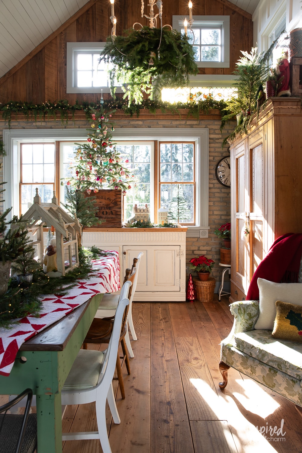 gorgeous barn decorated for Christmas with greenery and trees farmhouse Christmas decorating