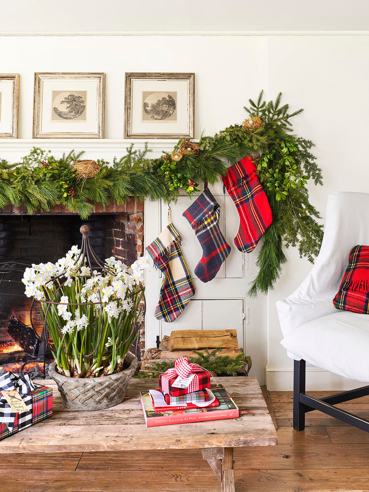classic Christmas living room with plaid stockings and garland on mantel