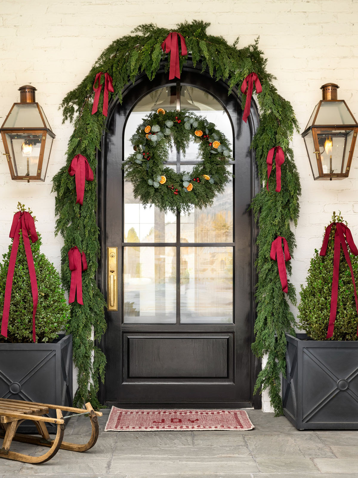 Classic Christmas Decor: 20 Stunning Ideas to Inspire gorgeous classic Christmas porch with wreath and red ribbon