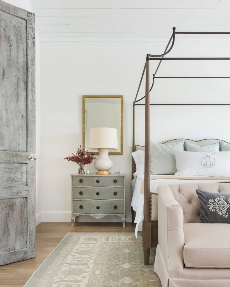 elevating your bedroom gorgeous primary bedroom with painted nightstand canopy bed and patterned rug