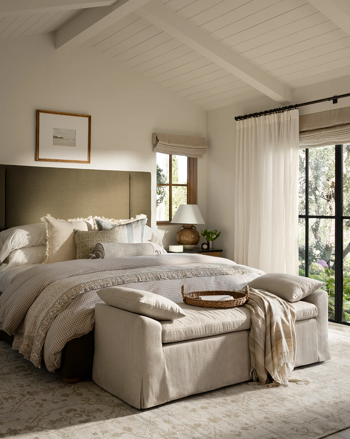 neutral bedroom with upholstered headboard and bed bench 
