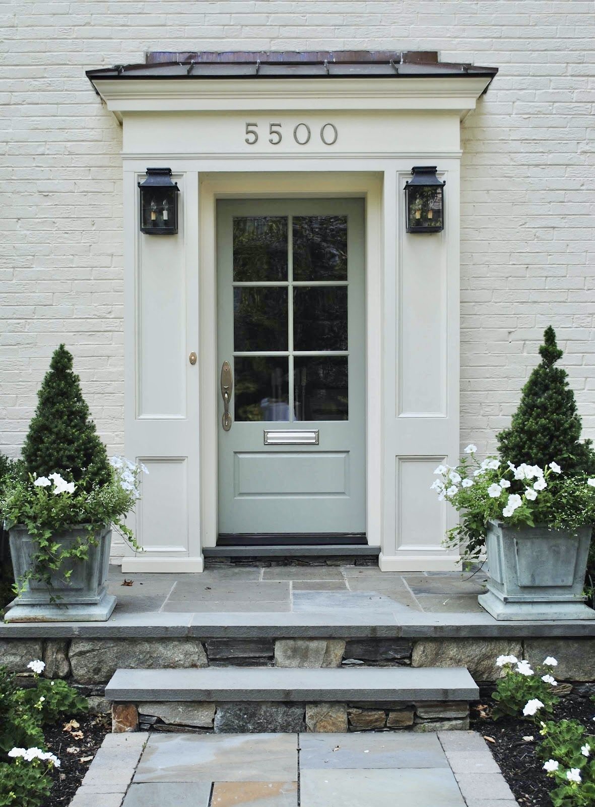 5 Tips for Elevating Your Front Porch elevate your front porch with pretty lanterns and brass house numbers and a green door